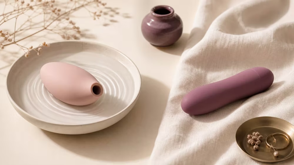 A focused external stimulator in a calm editorial bathroom setting