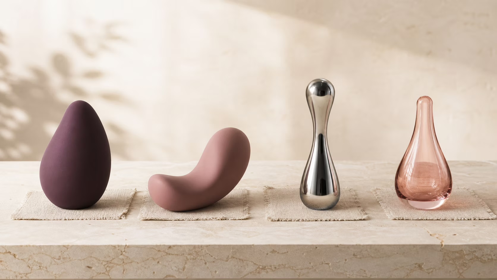 Silicone, steel and glass pleasure products arranged to compare material surfaces
